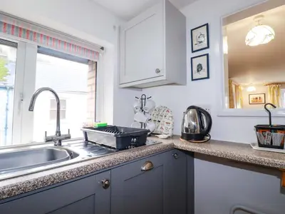 a kitchen with a sink and a counter top at The Penthouse in Looe