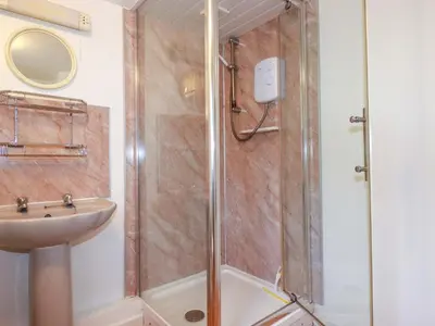 a bathroom with a shower and a sink at The Penthouse in Looe