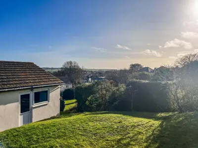 a house on a hill with a green yard at Hillside in St Austell