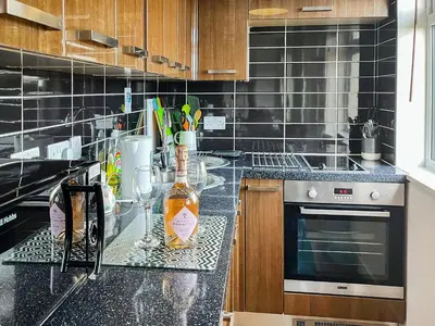 a kitchen with a bottle of alcohol on a counter at Hillside in St Austell