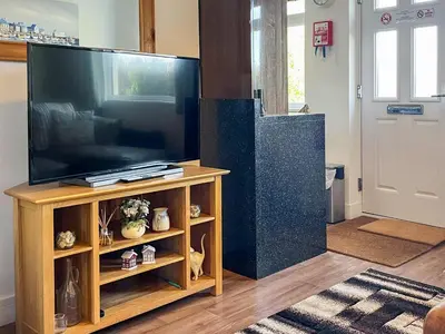 a living room with a large flat screen tv at Hillside in St Austell
