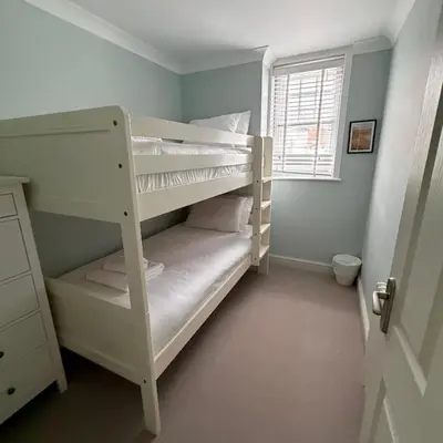 two bunk beds in a room with a window at No 1 Exbury Padstow in Padstow