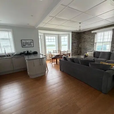 a large living room with a couch and a table at No 1 Exbury Padstow in Padstow