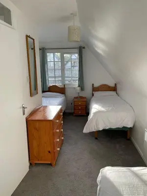 a bedroom with two beds and a dresser and a window at Cosy 3 bedroon chalet close to Hayle, 40 Tudor Court in Hayle