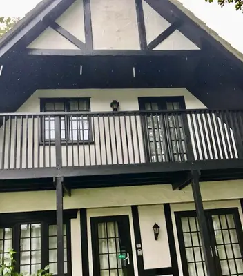 a black and white house with a balcony at Cosy 3 bedroon chalet close to Hayle, 40 Tudor Court in Hayle