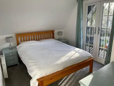 a bedroom with a large bed and a window at Cosy 3 bedroon chalet close to Hayle, 40 Tudor Court in Hayle