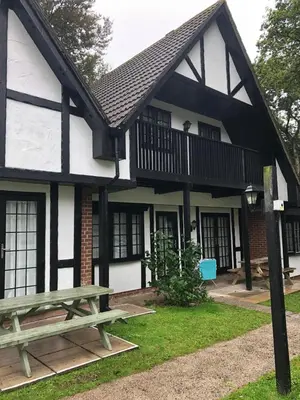a building with a picnic table in front of it at Cosy 3 bedroon chalet close to Hayle, 40 Tudor Court in Hayle