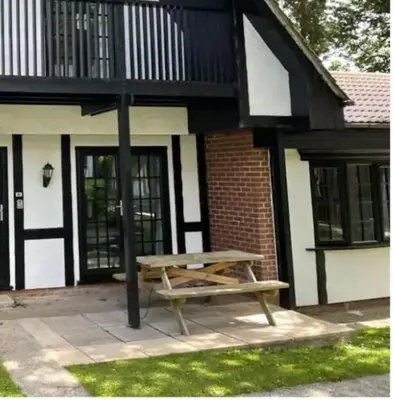 a wooden picnic table in front of a building at Cosy 3 bedroon chalet close to Hayle, 40 Tudor Court in Hayle