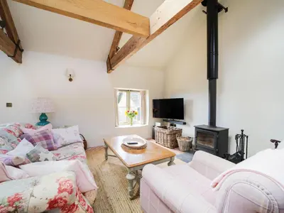 a living room with a couch and a table at Bospebo Cottage in Camborne