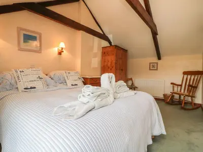 a bedroom with a bed with towels on it at Applestore in Wadebridge