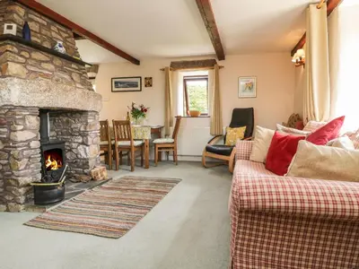 a living room with a couch and a fireplace at Applestore in Wadebridge