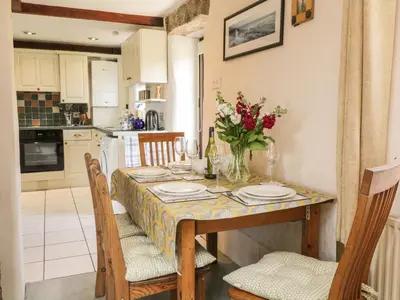 a kitchen and dining room with a table and chairs at Applestore in Wadebridge