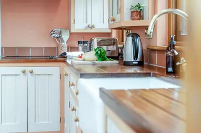 a kitchen with white cabinets and a counter top with a sink at 2 Bed in Widemouth Bay oc-s34972 in Widemouth Bay