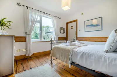 a bedroom with a bed and a window at 2 Bed in Widemouth Bay oc-s34972 in Widemouth Bay