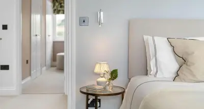 a bedroom with a bed and a table with a lamp at Luxury seaside home - 5 mins walk to beach - hot tub in Downderry