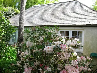 a house with pink flowers in front of it at Porthallow Lodge 350m to SWCP Talland Bay Retreat in Talland