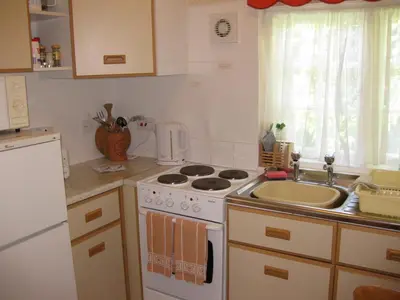 a kitchen with a stove top oven next to a sink at Porthallow Lodge 350m to SWCP Talland Bay Retreat in Talland