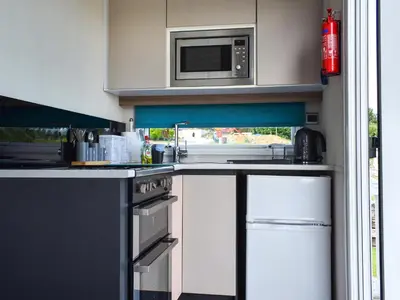 a kitchen with a stove and a microwave at Valley View - Uk50320 in Liskeard