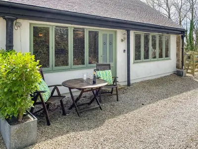 a table and chairs in front of a house at Dune Cottage - Uk48934 in Saint Erth