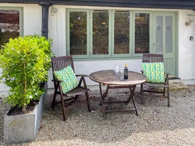 a table and two chairs with a bottle of wine at Dune Cottage - Uk48934 in Saint Erth