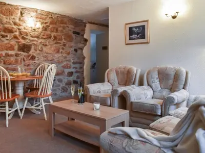 a living room with chairs and a table at Henhouse - Uk49016 in Liskeard