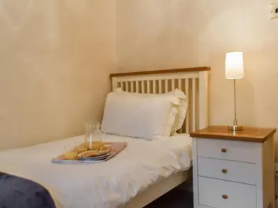 a bed with a plate of fruit on it at Haybarn - Uk49019 in Liskeard