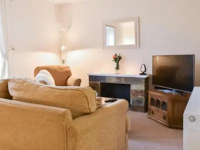 a living room with a couch and a television at Milking Parlour - Uk49026 in Liskeard