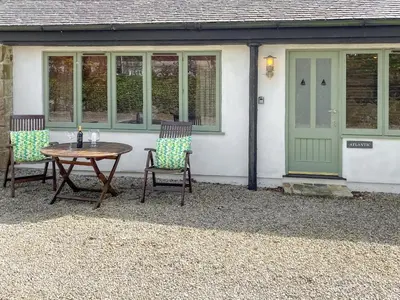 a table and chairs in front of a house at Atlantic Cottage - Uk48935 in Saint Erth