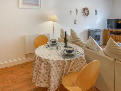 a living room with a table and a couch at Atlantic Cottage - Uk48935 in Saint Erth