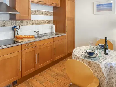 a kitchen with a table and a sink at Atlantic Cottage - Uk48935 in Saint Erth