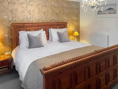a bedroom with a large bed with white sheets and pillows at Atlantic Cottage - Uk48935 in Saint Erth