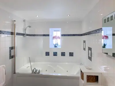 a white bathroom with a tub and a window at Atlantic Cottage - Uk48935 in Saint Erth