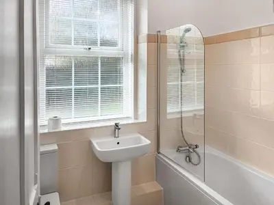 a white bathroom with a sink and a shower at The Farmhouse - Uk49068 in Liskeard