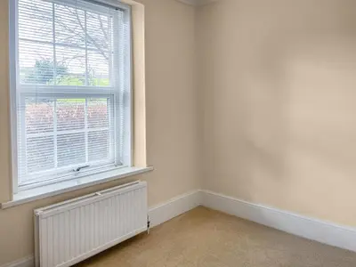 an empty room with a radiator and a window at The Farmhouse - Uk49068 in Liskeard