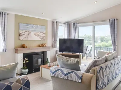 a living room with a couch and a television at Edmonton Lodge - Uk50308 in Doublebois