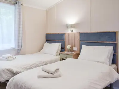 a room with two beds and a window at Edmonton Lodge - Uk50308 in Doublebois