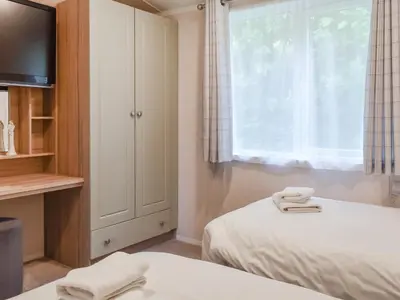 a bedroom with two beds and a window at Edmonton Lodge - Uk50308 in Doublebois