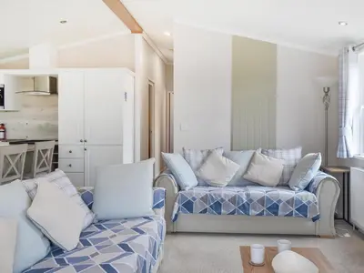 a living room with two couches and a table at Edmonton Lodge - Uk50308 in Doublebois