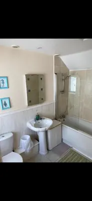 a bathroom with a sink and a toilet and a shower at Sunset Apartments Newquay in Newquay