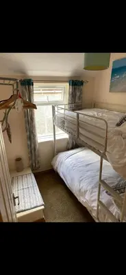 a bedroom with two bunk beds and a window at Sunset Apartments Newquay in Newquay