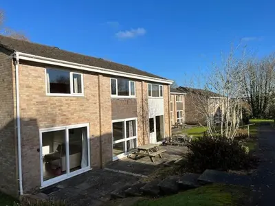 a brick building with a bench in front of it at Entire 2 bedroom house in a great Cornish location in Saint Columb Road Station