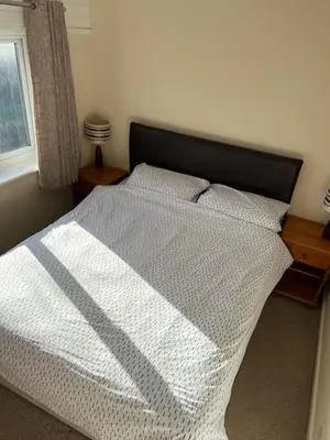 a bedroom with a bed with a black and white blanket at Entire 2 bedroom house in a great Cornish location in Saint Columb Road Station