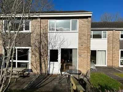 a building with a patio with a table and chairs at Entire 2 bedroom house in a great Cornish location in Saint Columb Road Station