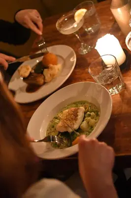 a table with a bowl of soup and plates of food at The Copley Arms in Downderry