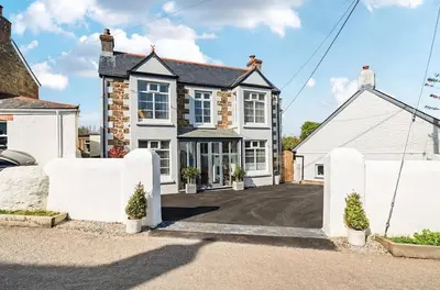 an exterior view of a house with a driveway at Idyllic Cornish House in St. Agnes