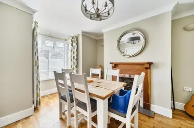 a dining room with a table and chairs and a mirror at Idyllic Cornish House in St. Agnes
