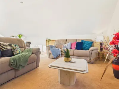 a living room with two couches and a coffee table at The Crows Nest – Sea View Retreat, Flushing Cornwall in Falmouth