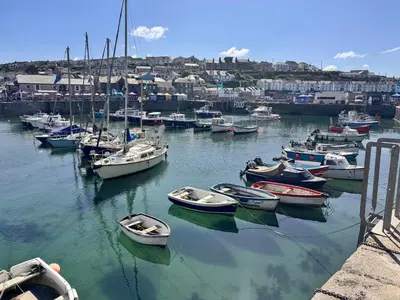a bunch of boats are docked in a harbor at Harbour Hideaway, Porthleven in Porthleven