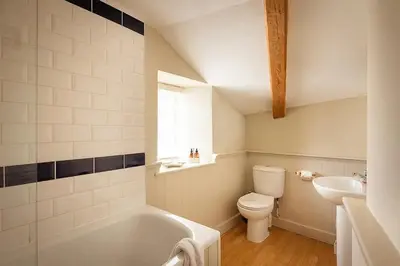 a bathroom with a tub and a toilet and a sink at Homelands in Port Isaac