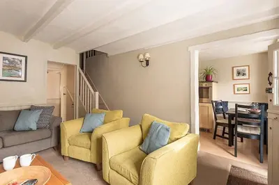 a living room with two chairs and a table at Homelands in Port Isaac